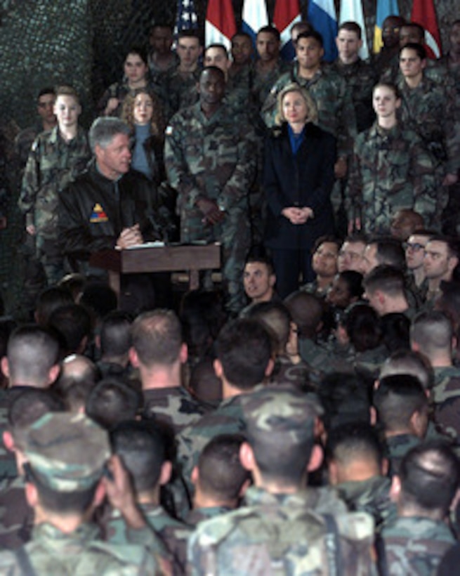 President Bill Clinton talks to Task Force Eagle soldiers at the 21 Club, Eagle Base, Tuzla, Bosnia and Herzegovina, on Dec. 22, 1997. The president was accompanied by his wife Hillary, their daughter Chelsea, former Senator Bob Dole and his wife Elizabeth, for the holiday visit with the troops in Tuzla. 