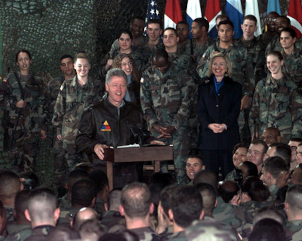 President Bill Clinton cracks jokes as he talks to Task Force Eagle soldiers at the 21 Club, Eagle Base, Tuzla, Bosnia and Herzegovina, on Dec. 22, 1997. The president was accompanied by his wife Hillary, their daughter Chelsea, former Senator Bob Dole and his wife Elizabeth, for the holiday visit with the troops in Tuzla. 