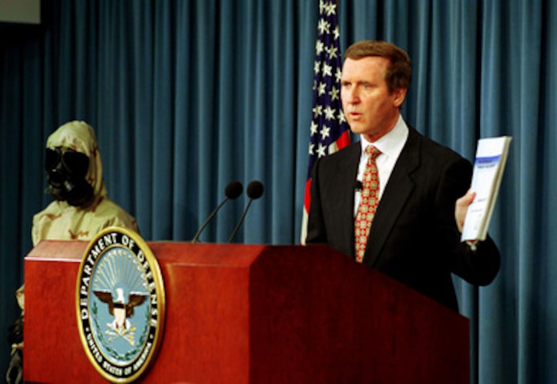 Secretary of Defense William S. Cohen holds a copy of "Proliferation: Threat and Response" during a Pentagon press briefing on Nov. 25, 1997. Cohen released the second edition of the report which discusses the worldwide threat of nuclear, chemical, and biological weapons and the Department of Defense response to counter these threats. 