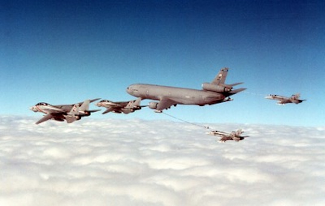 Two U.S. Navy F-14B Tomcats (left) fly in formation with a U.S. Air Force KC-10 Extender (center) as it refuels two Navy F/A-18C Hornets (right) over the Persian Gulf on Dec. 29, 1997. The Tomcats and the Hornets are part of Carrier Air Wing One embarked on the aircraft carrier USS George Washington (CVN 73). The Washington is operating in the Persian Gulf in support of Operation Southern Watch which is the U.S. and coalition enforcement of the no-fly-zone over Southern Iraq. The Extender is deployed to the Persian Gulf area of operations from Travis Air Force Base, Calif. 