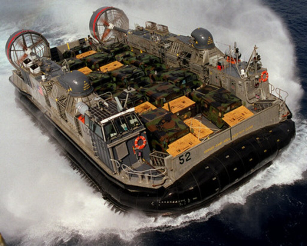 A U.S. Navy Landing Craft Air Cushion, of Assault Craft Unit 5, flies off the coast of Camp Pendleton, Calif., on June 20, 1997, delivering troops and cargo to the USS Peleliu (LHA 5) during Exercise Kernel Blitz 97. Kernel Blitz 97 is a major amphibious exercise taking place in Southern California and waters offshore. More than 12,000 sailors, Marines, soldiers, guardsmen and airmen are involved in the exercise which is designed to test the Navy-Marine Corps team's ability to project combat power ashore. 