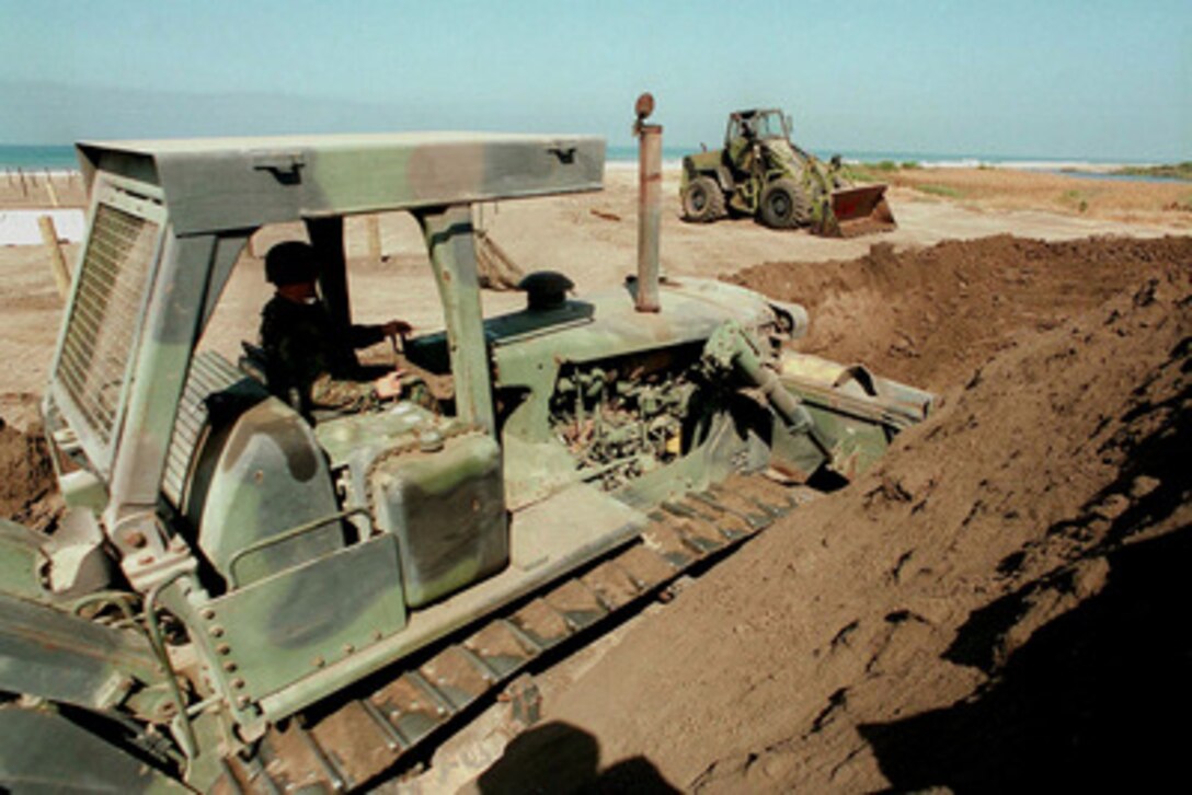 Soldiers from the U.S. Army National Guard dig a trench as one of the obstacles on Red Beach at Camp Pendleton, Calif., on June 24, 1997, during Exercise Kernel Blitz 97. Kernel Blitz 97 is a major amphibious exercise taking place in Southern California and waters offshore. More than 12,000 sailors, Marines, soldiers, guardsmen and airmen are involved in the exercise which is designed to test the Navy-Marine Corps team's ability to project combat power ashore. The guardsmen are from the 578th Engineer Battalion, Kearny Mesa, Calif. 