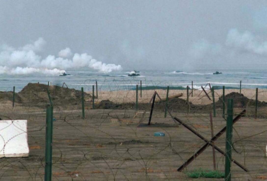 A wave of amphibious assault vehicles approach the heavily obstructed Red Beach at Camp Pendleton, Calif., during Exercise Kernel Blitz 97, on June 28, 1997. Kernel Blitz 97 is a major amphibious exercise taking place in Southern California and waters offshore. More than 12,000 sailors, Marines, soldiers, guardsmen and airmen are involved in the exercise which is designed to test the Navy-Marine Corps team's ability to project combat power ashore. 