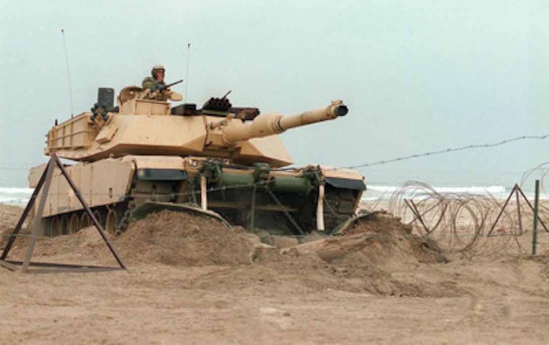 A M-1A1 Abrams tank uses a mine plow to breach some of the obstacles on Red Beach during the amphibious assault phase of Exercise Kernel Blitz 97 at Camp Pendleton, Calif., on June 28, 1997. Kernel Blitz 97 is a major amphibious exercise taking place in Southern California and waters offshore. More than 12,000 sailors, Marines, soldiers, guardsmen and airmen are involved in the exercise which is designed to test the Navy-Marine Corps team's ability to project combat power ashore. The Abrams is from the 1st Tank Battalion, 1st Marine Division. 