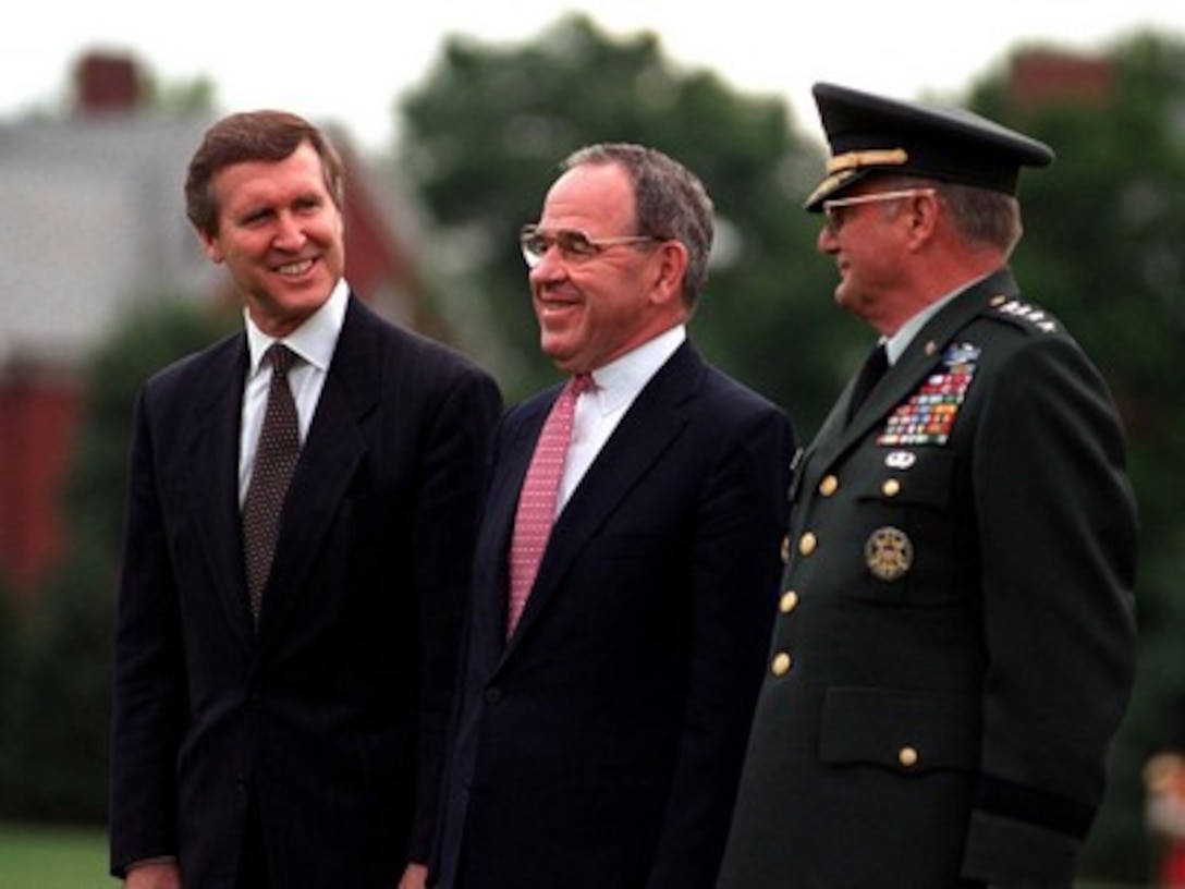Secretary of Defense William S. Cohen (left) and Gen. John M. Shalikashvili (right), U.S. Army, chairman of the Joint Chiefs of Staff, flank Deputy Secretary of Defense John P. White during an Armed Forces Full Honor Review and Award ceremony on June 30, 1997. Cohen and Shalikashvili are hosting the farewell ceremony for White at Fort Myer, Va. 