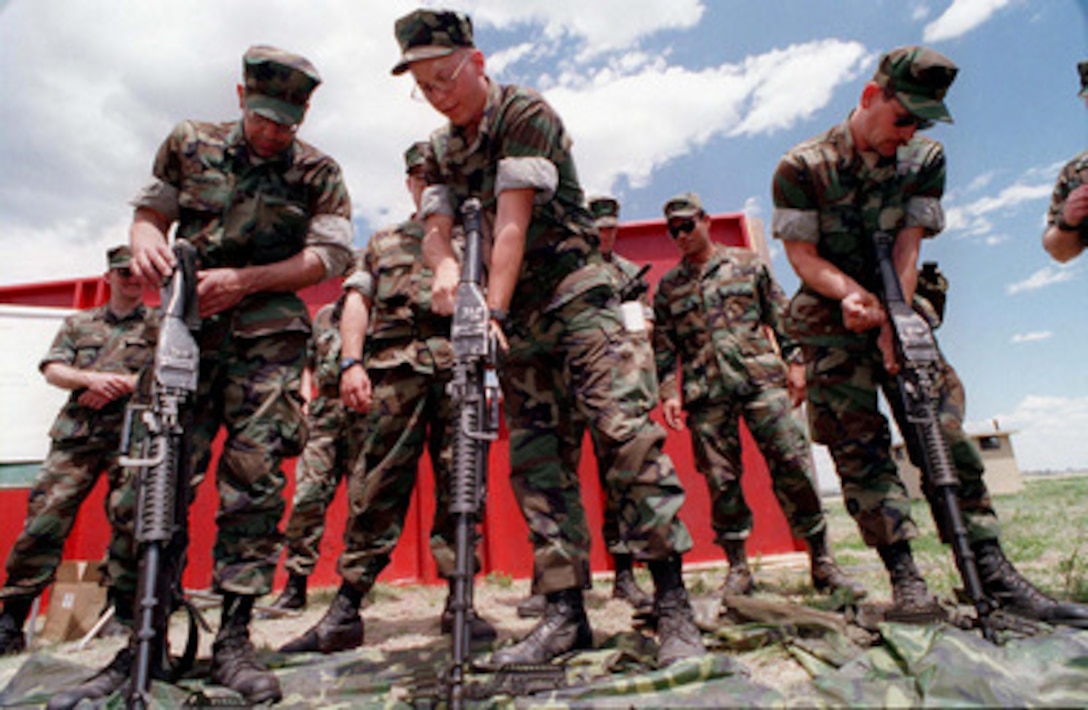 U.S. Navy Seabees from Naval Mobile Construction Battalion 17 learn the mechanics of the M-60E3 machine gun during Exercise Mountain Bee '97 at Fort Carson, Colo., on May 16, 1997. The exercise will give the reserve Seabees in-field training on the use of weapons, medical evacuations, communications, logistics and other combat related training. 