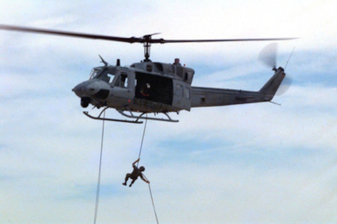 Marines of the 2nd Reconnaissance Battalion practice their repelling from a UH-1 Huey helicopter at the Marine Corps Air Ground Combat Center, Twentynine Palms, Calif., during Combined Arms Exercise 5-97, on May 5, 1997. The Marine Air Ground Task Force exercise is allowing these Marines to practice their desert warfare. Repelling from a helicopter allows the Marines to be inserted into a hostile environment in the least amount of time. 