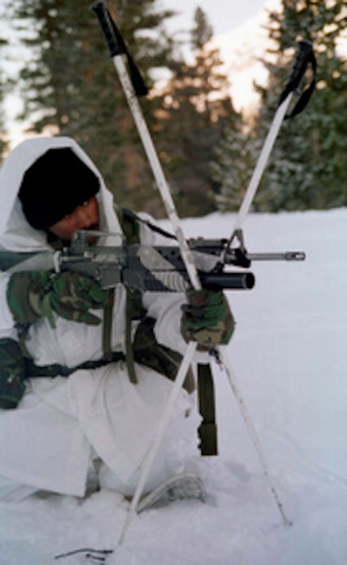 A 1st Platoon, Lima Company Marine uses his ski poles to steady his M-16A2 rifle during a live fire exercise at the Mountain Warfare Training Center, Bridgeport, Calif., on Feb. 8, 1997. Marines from the 2nd Marine Regiment and 3rd Battalion, 8th Marines of Camp Lejeune, N. C., are at the Center to train in cold weather survival and arctic warfare. This M-16A2 is equipped with a M-203 40 mm grenade launcher. 