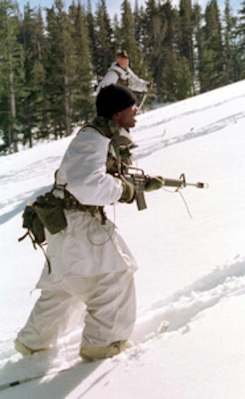 A U.S. Marine from Kilo Company patrols on snow shoes up a snowy slope with his squad at the Mountain Warfare Training Center, Bridgeport, Calif., on Feb. 14, 1997. Marines from the 2nd Marine Regiment and 3rd Battalion, 8th Marines of Camp Lejeune, N. C. are at the Center to train in cold weather survival and arctic warfare. 