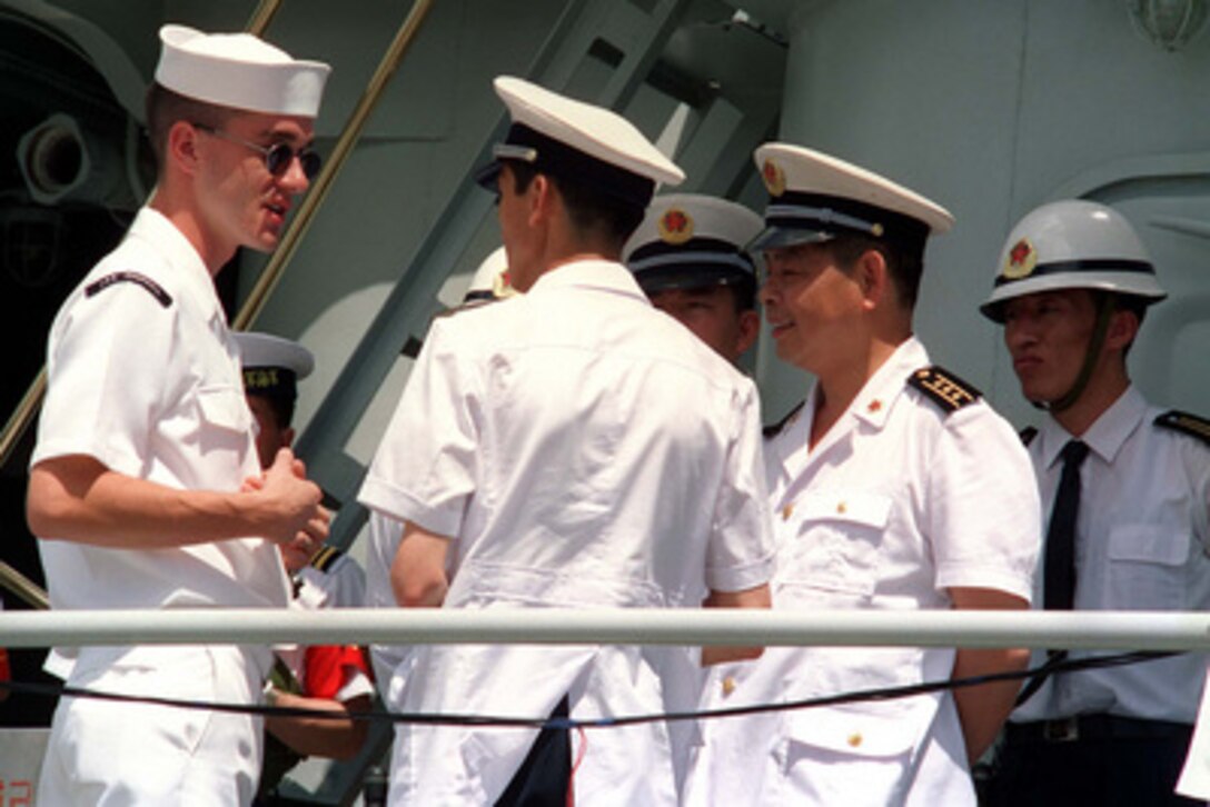 A U.S. Navy sailor talks to People's Republic of China Navy sailors at Pearl Harbor, Hawaii, on March 9, 1997. Three People's Republic of China ships are visiting Hawaii for the first part of a scheduled goodwill visit between the U.S. and Chinese navies. The ships will continue on to San Diego, Calif., for a first-ever visit by People's Republic of China Navy ships to the mainland U.S. The U.S. and the People's Republic of China navies are the two largest fleets in the Asia-Pacific region. Interaction between the two navies increases mutual understanding and confidence. During the visits, Chinese sailors will have the opportunity to meet their U.S. Navy counterparts, tour U.S. ships, experience American culture in Hawaii and Southern California, and learn about the United States. 