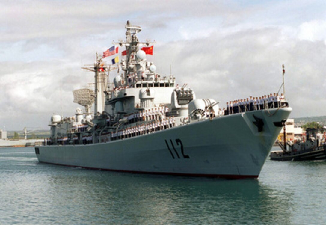Crew members man the rail as the People's Republic of China destroyer Harbin (DD 112) pulls into Pearl Harbor, Hawaii, on March 9, 1997. Harbin and two other People's Republic of China ships are visiting Hawaii for the first part of a scheduled goodwill visit between the U.S. and Chinese navies. The ships will continue on to San Diego, Calif., for a first-ever visit by People's Republic of China Navy ships to the mainland U.S. The U.S. and the People's Republic of China navies are the two largest fleets in the Asia-Pacific region. Interaction between the two navies increases mutual understanding and confidence. During the visits, Chinese sailors will have the opportunity to meet their U.S. Navy counterparts, tour U.S. ships, experience American culture in Hawaii and Southern California, and learn about the United States. 