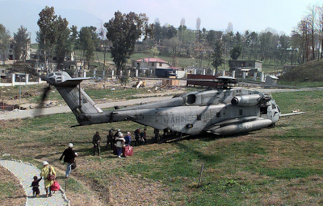 American citizens board a U.S. Marine Corps CH-53 Super Stallion combat assault helicopter in a field inside the U.S. Embassy housing compound in Tirana, Albania, on March 15, 1997. Operation Silver Wake is the evacuation of noncombatants from Albania to ensure the safety of American citizens and designated third country nationals. U.S. Naval forces from the USS Nassau (LHA 4) Amphibious Readiness Group continue to evacuate citizens from the U.S. Embassy in Tirana. 