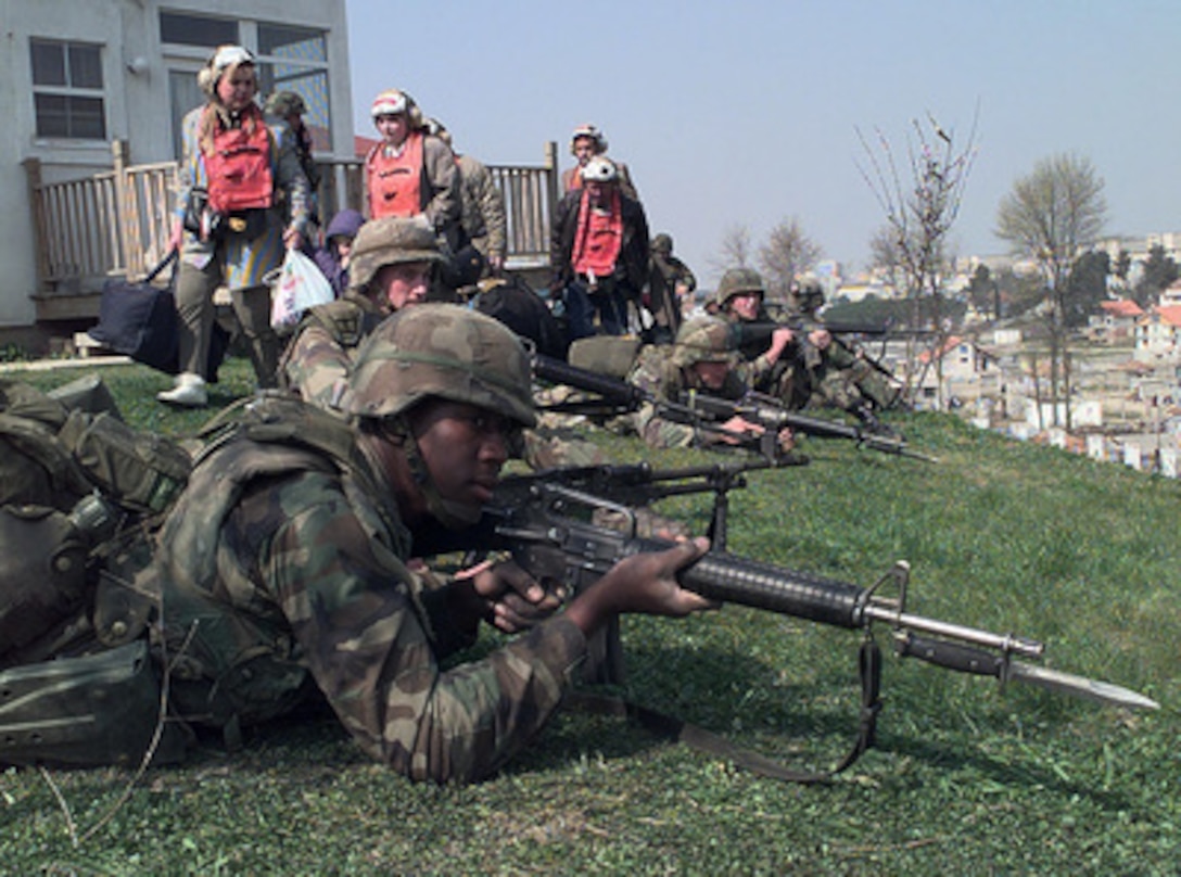 American citizens board a U.S. Marine Corps CH-53 Super Stallion combat assault helicopter in a field inside the U.S. Embassy housing compound in Tirana, Albania, on March 15, 1997. Operation Silver Wake is the evacuation of noncombatants from Albania to ensure the safety of American citizens and designated third country nationals. U.S. Naval forces from the USS Nassau (LHA 4) Amphibious Readiness Group continue to evacuate citizens from the U.S. Embassy in Tirana. 