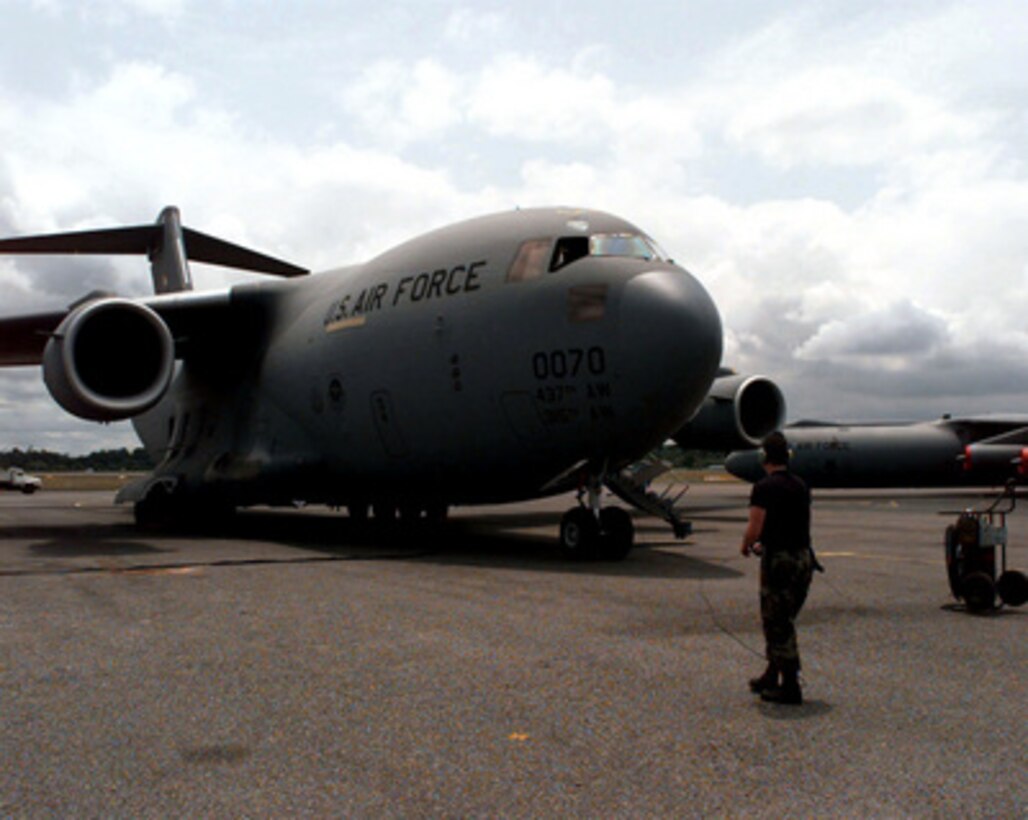 Senior Airman Scott Mousseau preflights a C-17 Globemaster III prior to take off from the Libreville International Airport, Republic of Gabon, on March 24, 1997. Command and support elements for a forward joint task force and other enabling elements are deploying to locations in several West African countries as part of contingency planning for a possible future evacuation from Zaire. The deployment is an enhancement to planning for contingency measures to ensure the security of U.S. citizens in Zaire if an evacuation should become necessary. Mousseau is attached to the 637th Aircraft Generation Squadron, Charleston Air Force Base, S.C. 