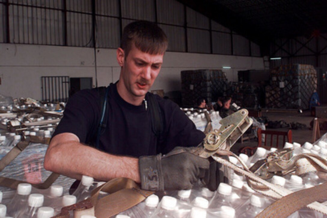 Senior Airman John Syme breaks down a pallet of water bottles in a hangar at the Libreville International Airport, Republic of Gabon, on March 26, 1997. Command and support elements for a forward joint task force and other enabling elements are deploying to locations in several West African countries as part of contingency planning for a possible future evacuation from Zaire. The deployment is an enhancement to planning for contingency measures to ensure the security of U.S. citizens in Zaire if an evacuation should become necessary. Syme is an air transportation specialist with the 621st Aerial Port Squadron, McGuire Air Force Base, N.J. 
