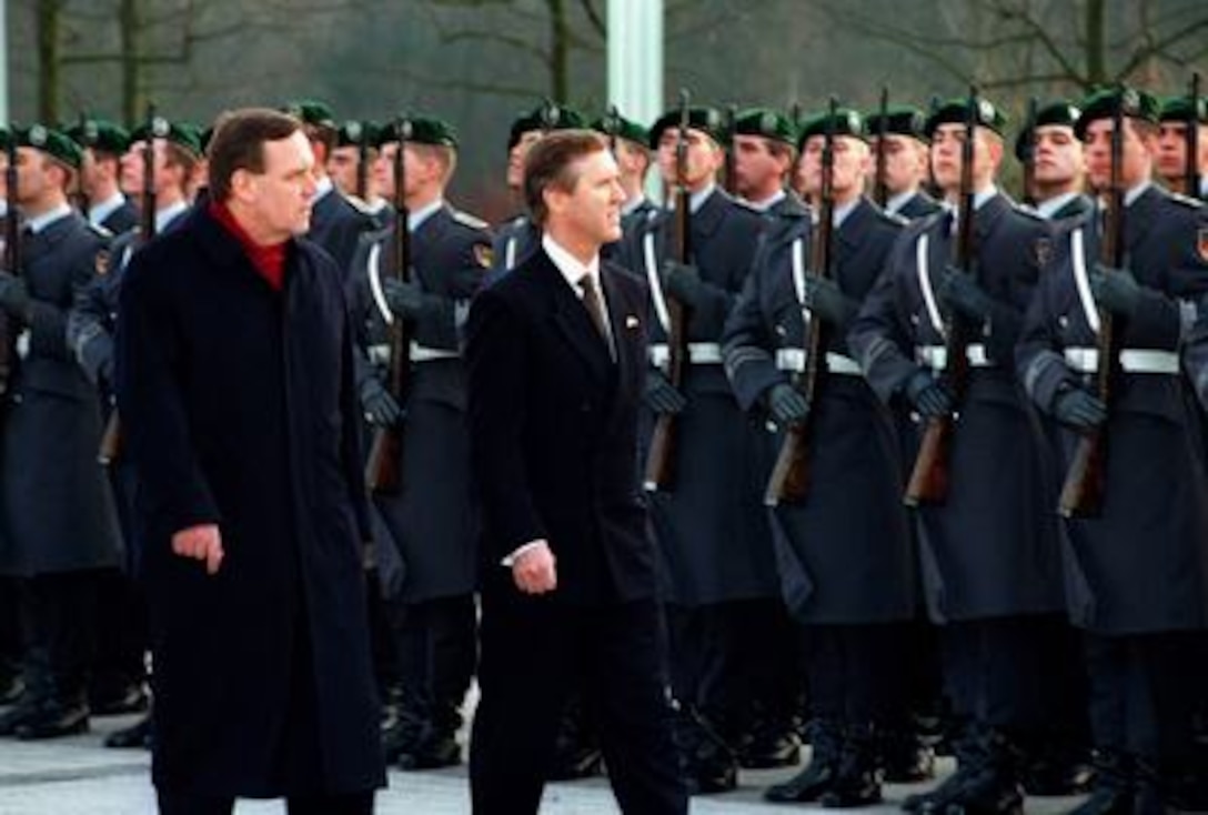 Minister of Defense of the Federal Republic of Germany Volker Ruehe (left) escorts Secretary of Defense William S. Cohen (right) as he reviews the troops during an armed forces honor ceremony. Cohen was welcomed to the Ministry of Defense in Bonn, Germany, on March 4, 1997. 