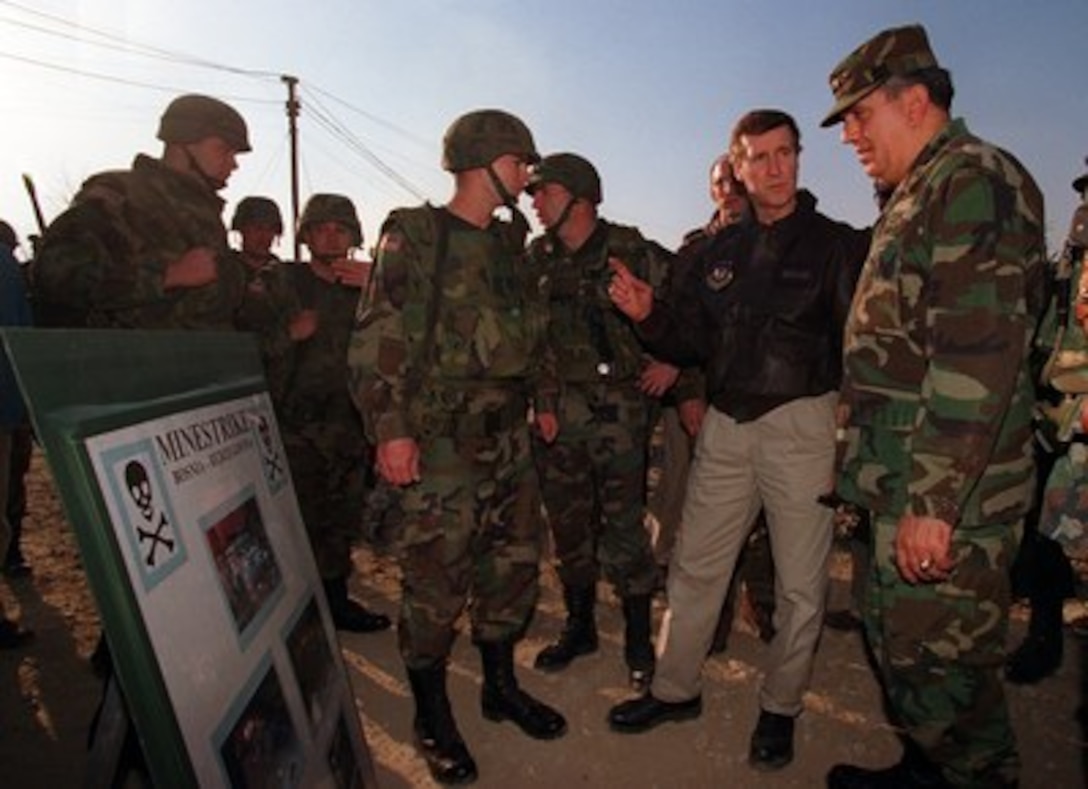Gen. George A. Joulwan (right), Supreme Allied Commander, Europe, listens as Secretary of Defense William S. Cohen (center) makes a comment during a meeting on March 6, 1997, with soldiers who survived a mine explosion while traveling in their Humvee in Bosnia and Herzegovina. Cohen toured Camp McGovern and addressed troops there. This is his first visit to NATO's stabilization force operation since taking office in January. 