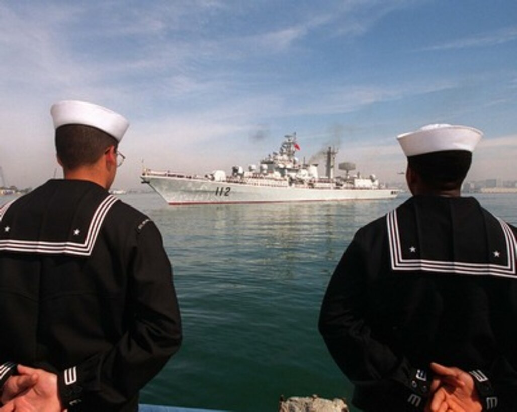 The People's Republic of China destroyer Harbin (DD 112) is framed between two U. S. Navy sailors as the ship pulls into San Diego, Calif., on March 21, 1997, for a first-ever visit by People's Republic of China Navy ships to the mainland U.S. Harbin and two other People's Republic of China ships are visiting Southern California for the second part of a goodwill visit between the U.S. and Chinese navies. The ships visited Hawaii on their way to San Diego. The U.S. and the People's Republic of China navies are the two largest fleets in the Asia-Pacific region. Interaction between the two navies increases mutual understanding and confidence. During the visit Chinese sailors will have the opportunity to meet their U.S. Navy counterparts, tour U.S. ships and experience American culture in Southern California. The destroyers Harbin and Zhuhai, and supply ship Nancang will moor next to the U. S. Navy's aircraft carrier USS Constellation (CV 64), at Naval Air Station North Island. 
