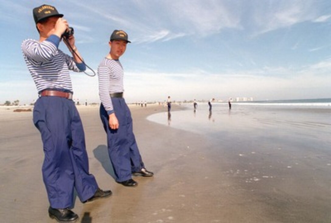 Sailors on liberty from the People's Republic of China destroyer Harbin (DD 112) enjoy the view from the beach at Naval Air Station North Island in San Diego, Calif., on March 21, 1997. The Harbin and two other People's Republic of China ships are visiting Southern California for the second part of a goodwill visit between the U.S. and Chinese navies. The ships visited Hawaii on their way to San Diego. The U.S. and the People's Republic of China navies are the two largest fleets in the Asia-Pacific region. Interaction between the two navies increases mutual understanding and confidence. During the visit Chinese sailors will have the opportunity to meet their U.S. Navy counterparts, tour U.S. ships and experience American culture in Southern California. The destroyers Harbin and Zhuhai, and supply ship Nancang will moor next to the U. S. Navy's aircraft carrier USS Constellation (CV 64), at Naval Air Station North Island. 