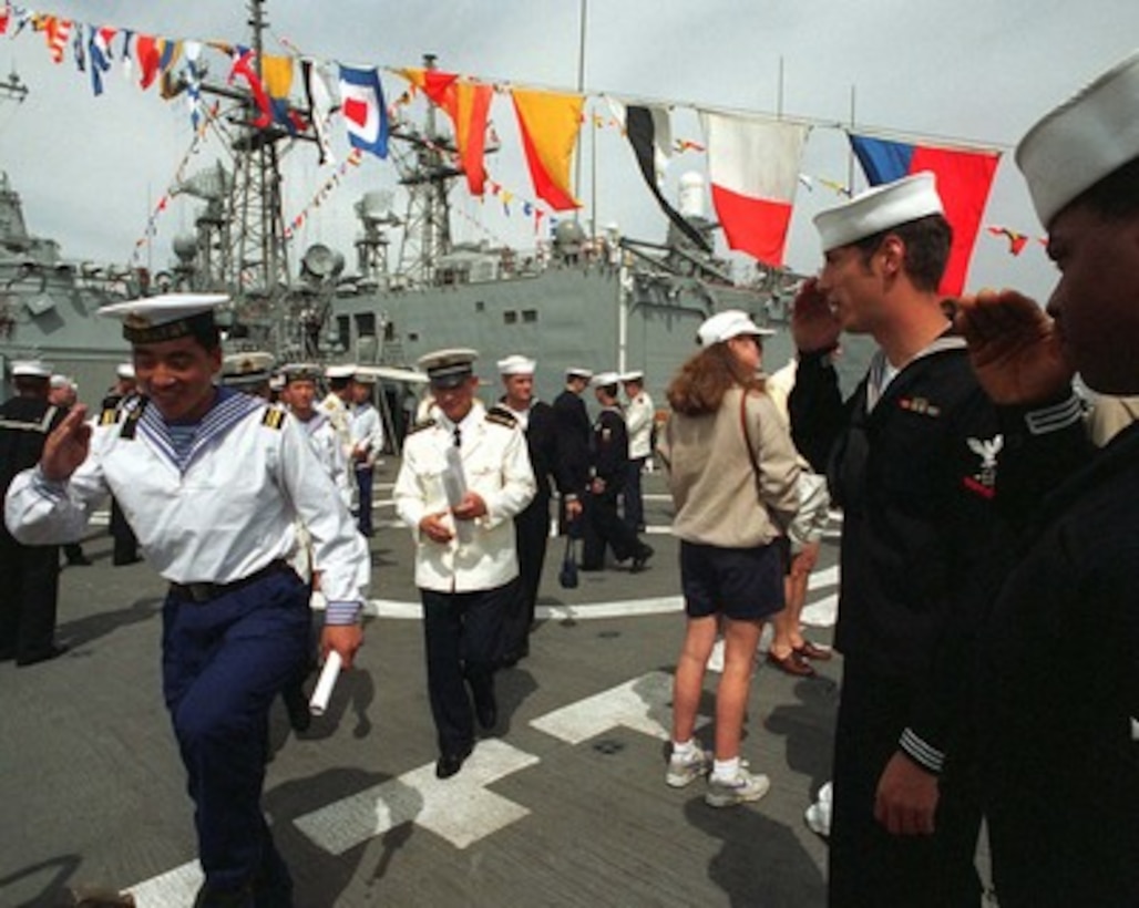 A People's Republic of China sailor salutes the quarter-deck watch as he goes ashore after touring the U. S. Navy destroyer USS John Paul Jones (DDG 53) in San Diego, Calif., on March 22, 1997. Three People's Republic of China Navy ships are in San Diego for a first-ever visit to the mainland U.S. as the second part of a goodwill visit between the U.S. and Chinese navies. The ships visited Hawaii on their way to San Diego. The U.S. and the People's Republic of China navies are the two largest fleets in the Asia-Pacific region. Interaction between the two navies increases mutual understanding and confidence. During the visit Chinese sailors will have the opportunity to meet their U.S. Navy counterparts, tour U.S. ships and experience American culture in Southern California. 
