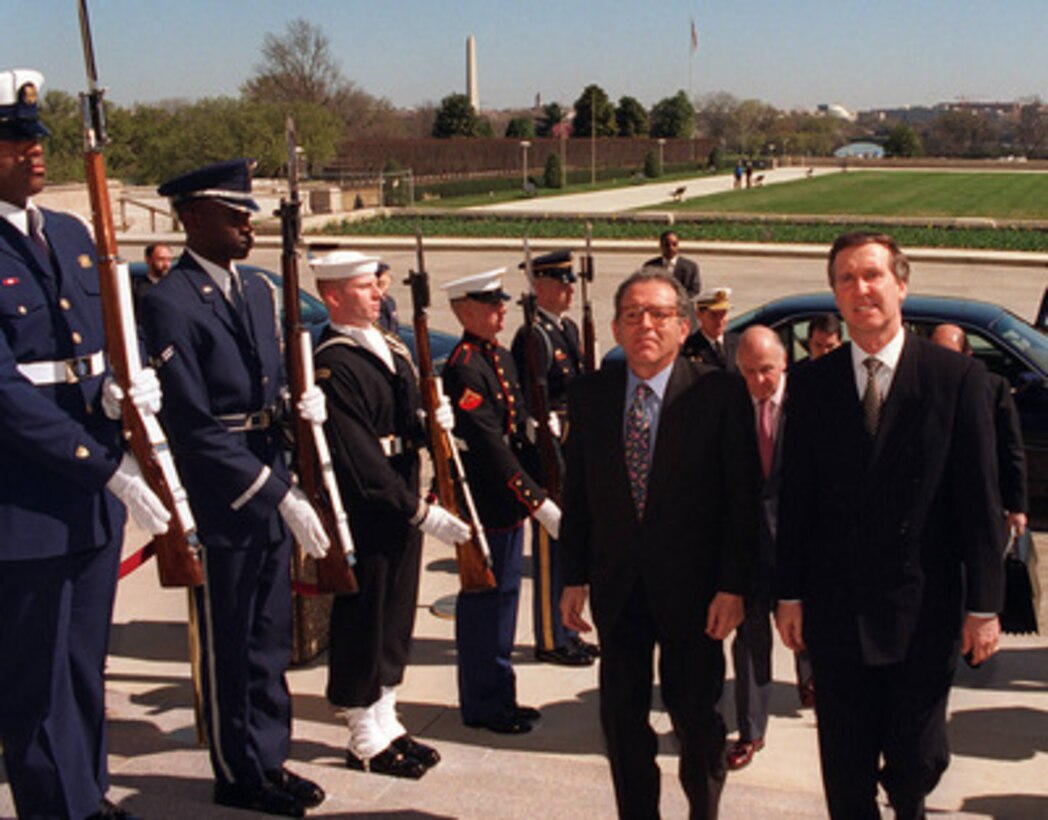 Secretary of Defense William S. Cohen (right) escorts Minister of Defense Eduardo Serra (left), of the Kingdom of Spain, through an Armed Forces Honor Cordon into the Pentagon on March 24, 1997. 