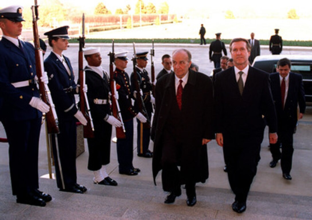 Secretary of Defense William S. Cohen (right) escorts President Alija Izetbegovic (left), of the Republic of Bosnia and Herzegovina, through an Armed Forces Honor Cordon into the Pentagon on March 24, 1997. 