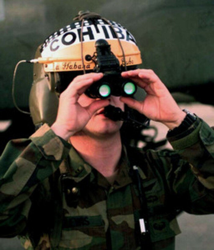Chief Warrant Officer Myke Lewis, U.S. Army, positions his night vision goggles on his flight helmet in preparation for a night helicopter mission at Alamagordo, N.M., on April 20, 1997, during Exercise Roving Sands 97. More than 20,000 service members from all branches of the armed forces of the U.S., Canada, Germany, and the Netherlands are participating in Exercise Roving Sands 97. The exercise is designed to refine their skills in operations using an integrated air defense network of ground, missile and radar early warning systems combined with tactical fighter and bomber aircraft operating in a simulated high-threat environment. Lewis is deployed for the exercise from the 3rd Battalion, 101st Aviation Regiment, Fort Campbell, Ky. 