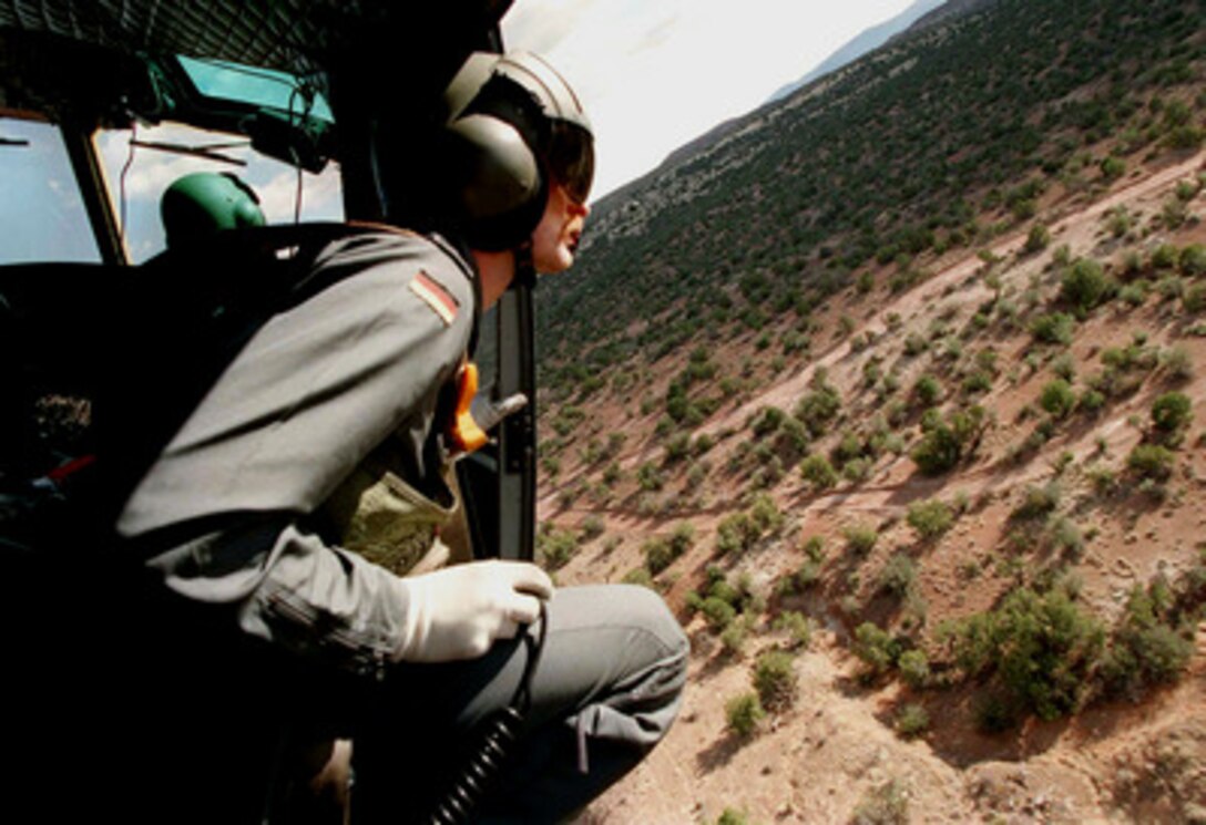 Master Sgt. Ulli Janzen looks out for birds and aircraft during a familiarization flight over the Alamogordo, N.M., bombing range on April 18, 1997, before the start of Exercise Roving Sands 97. More than 20,000 service members from all branches of the armed forces of the U.S., Canada, Germany, and the Netherlands are participating in Exercise Roving Sands 97. The exercise is designed to refine their skills in operations using an integrated air defense network of ground, missile and radar early warning systems combined with tactical fighter and bomber aircraft operating in a simulated high-threat environment. Janzen is a UH-1B helicopter flight engineer with Air Transport Wing 62/CSAR Germany. 