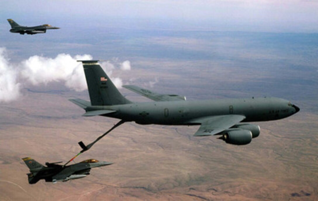 A U.S. Air Force KC-135 Stratotanker refuels a F-16 Fighting Falcon in the skies over New Mexico as part of Exercise Roving Sands '97 on April 21, 1997. The two F-16's are topping off their fuel tanks before beginning a bombing mission. More than 20,000 service members from all branches of the armed forces of the U.S., Canada, Germany, and the Netherlands are participating in Exercise Roving Sands '97. The exercise is designed to refine their skills in operations using an integrated air defense network of ground, missile and radar early warning systems combined with tactical fighter and bomber aircraft operating in a simulated high-threat environment. The Stratotanker is deployed from the 319th Air Refueling Wing, Grand Forks Air Force Base, N.D. The Fighting Falcons are operating out of the 524th Fighter Squadron, Cannon Air Force Base, N.M. 
