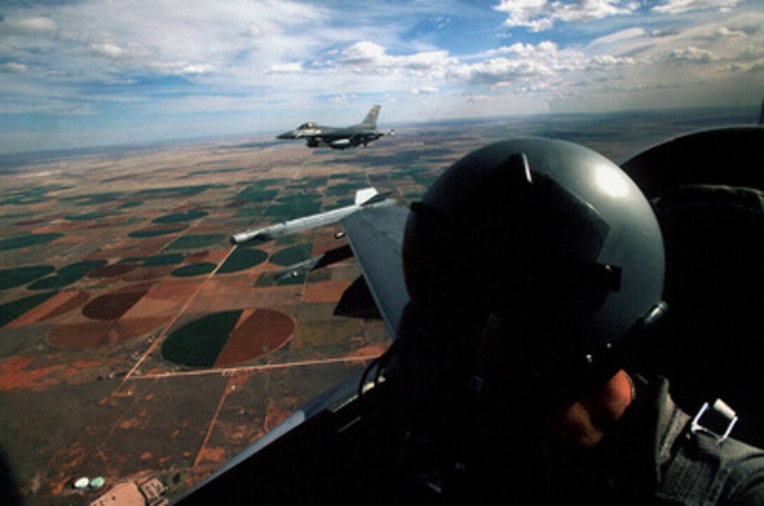 Two U.S. Air Force F-16 Fighting Falcons fly in a two ship formation in the skies over New Mexico before beginning a bombing mission as part of Exercise Roving Sands '97 on April 21, 1997. More than 20,000 service members from all branches of the armed forces of the U.S., Canada, Germany, and the Netherlands are participating in Exercise Roving Sands '97. The exercise is designed to refine their skills in operations using an integrated air defense network of ground, missile and radar early warning systems combined with tactical fighter and bomber aircraft operating in a simulated high-threat environment. The Fighting Falcons are operating out of the 524th Fighter Squadron, Cannon Air Force Base, N.M. 