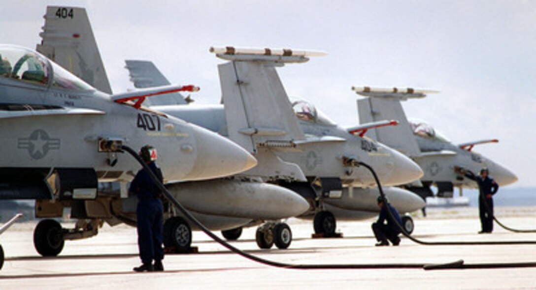 Three F/A-18 Hornets are hot refueled at Roswell Industrial Air Center, N.M., after an Exercise Roving Sands '97 mission over the New Mexico desert on April 22, 1997. More than 20,000 service members from all branches of the armed forces of the U.S., Canada, Germany, and the Netherlands are participating in Exercise Roving Sands '97. The exercise is designed to refine their skills in operations using an integrated air defense network of ground, missile and radar early warning systems combined with tactical fighter and bomber aircraft operating in a simulated high-threat environment. 