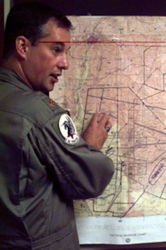 Maj. Clark Burtch, U.S. Air Force, points out the operating area for his flight of F-15 Eagles during a pre-flight brief for a Exercise Roving Sands '97 mission on April 23, 1997. More than 20,000 service members from all branches of the armed forces of the U.S., Canada, Germany, and the Netherlands are participating in Exercise Roving Sands '97. The exercise is designed to refine their skills in operations using an integrated air defense network of ground, missile and radar early warning systems combined with tactical fighter and bomber aircraft operating in a simulated high-threat environment. Burtch is deployed for the exercise from the 2nd Fighter Squadron, Tyndall Air Force Base, Fla. 