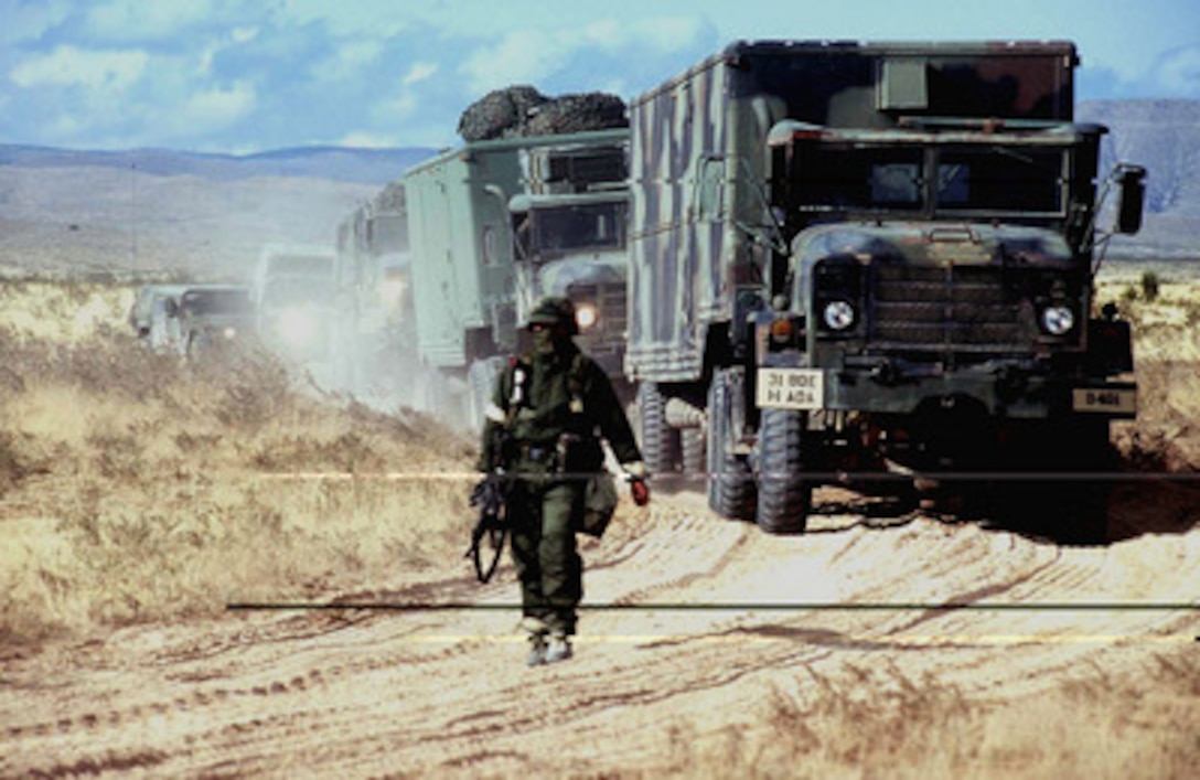 Vehicles of the 31st Air Defense Artillery Brigade Patriot missile battery are ground-guided by a soldier to their next site at Otero Mesa, N.M., on April 23, 1997, during Exercise Roving Sands '97. More than 20,000 service members from all branches of the armed forces of the U.S., Canada, Germany, and the Netherlands are participating in Exercise Roving Sands '97. The exercise is designed to refine their skills in operations using an integrated air defense network of ground, missile and radar early warning systems combined with tactical fighter and bomber aircraft operating in a simulated high-threat environment. The Patriot missile battery, used for land-to-air defense, and the soldiers are deployed from Alpha Battery, 1st Regiment, 1st Battalion, Fort Bliss, Texas. 