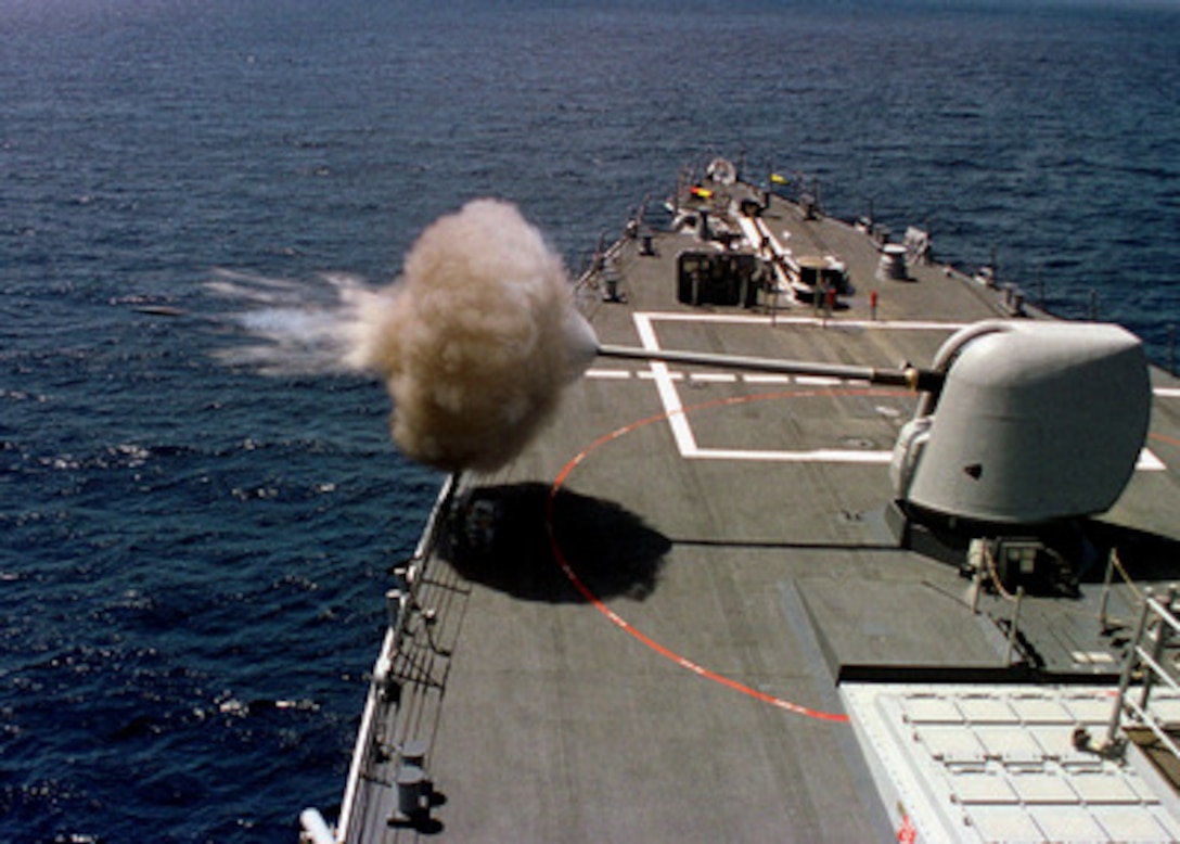 The Arleigh Burke class destroyer USS Benfold (DDG 65) fires its 5 inch gun during routine training operations off the coast of Southern California on April 16, 1997. The 5 inch/54 caliber MK 45 lightweight gun provides surface combatants with accurate naval gunfire against fast, highly maneuverable surface targets, air threats and shore targets. 