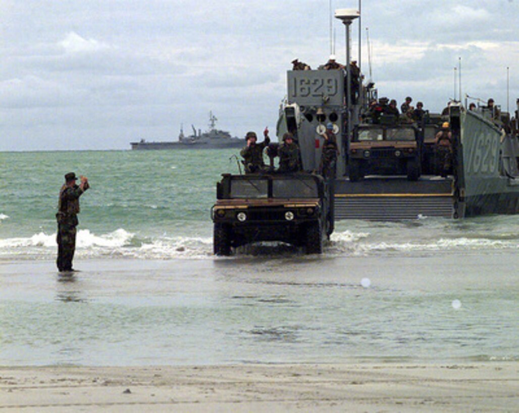 U.S. Marine Humvees drive through the surf to the beach near Hat Yai, Thailand, during an amphibious assault on May 20, 1997. The Navy Landing Craft Utility is carrying a cargo of Humvees and troops from offshore ships as part of Exercise Cobra Gold '97. Cobra Gold '97 is the latest in a continuing series of U.S. /Thai military exercises designed to ensure regional peace and strengthen the ability of the Royal Thai Armed Forces to defend Thailand. The training includes joint combined air, land and sea operations. Cobra Gold is the largest strategic mobility exercise involving the U.S. Pacific Command forces this year. 