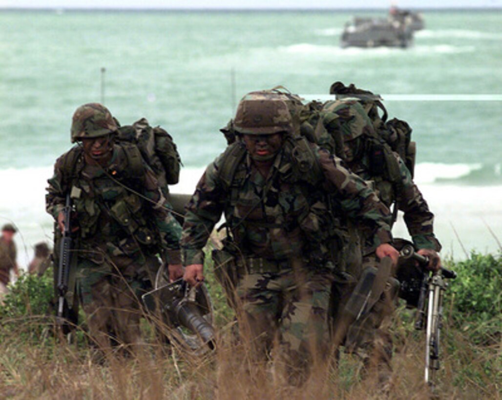 U.S. Marines hustle through the grass to their position as they assault Red Beach near Hat Yai, Thailand, during an amphibious assault on May 20, 1997. The Marines from 1st Battalion, 5th Marine Regiment, Camp Pendleton, Calif., are taking part in Exercise Cobra Gold '97. Cobra Gold '97 is the latest in a continuing series of U.S. /Thai military exercises designed to ensure regional peace and strengthen the ability of the Royal Thai Armed Forces to defend Thailand. The training includes joint combined air, land and sea operations. Cobra Gold is the largest strategic mobility exercise involving the U.S. Pacific Command forces this year. 