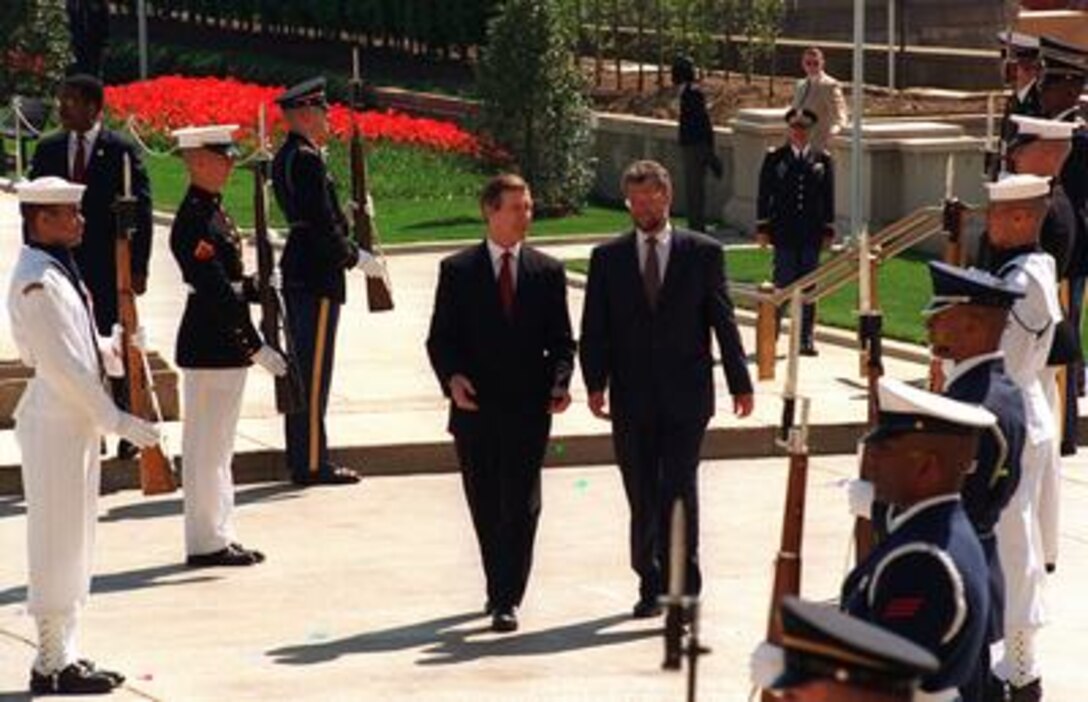 Secretary of Defense William Cohen (left) and visiting Danish Defense Minister Hans Haekkerup (right) walk back to the Pentagon at the conclusion of a full honor military ceremony welcoming him to the Pentagon, April 30, 1997. Later the two defense leaders met to discuss a range of security issues of interest to both nations. 