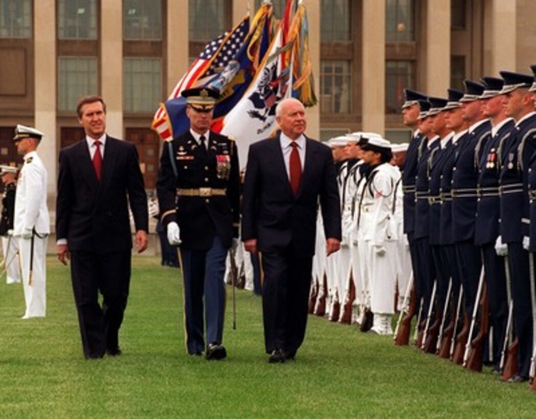 Secretary of Defense William S. Cohen (left), accompanied by Col. David H. Huntoon, U.S. Army, commander of the 3rd U.S. Infantry (The Old Guard) (center), escorts visiting Russian Minister of Defense Igor Nikolayevich Rodionov (right) as he inspects the joint services honor guard during welcoming ceremonies at the Pentagon, May 13, 1997. Minister Rodionov spent two days in Washington, D. C., meeting with senior officials of the State and Defense Departments, conferring on a variety of security issues ranging from the proposed eastward expansion of NATO to strategic arms reduction, and various military to military cooperation projects with the United States. 