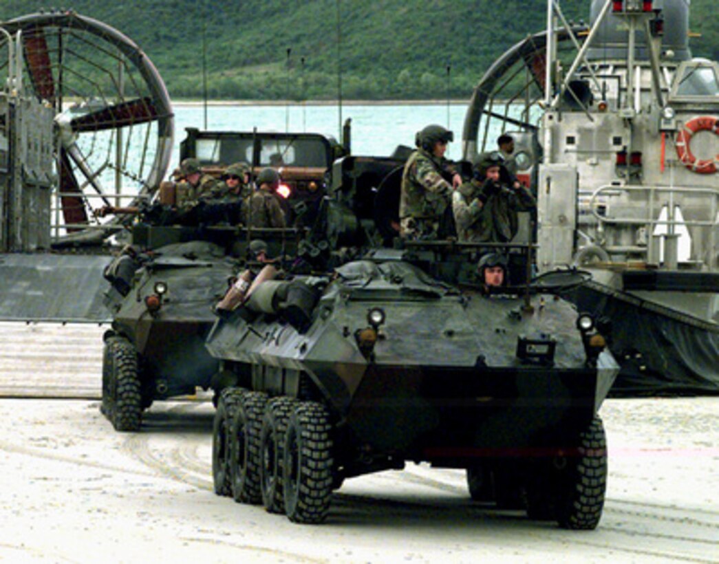 U.S. Marines drive Light Armored Vehicles off of a U.S. Navy Landing Craft Air Cushion on the beach near Hat Yai, Thailand, during an amphibious assault on May 21, 1997. The Landing Craft Air Cushion, or LCAC as it is more commonly known, is carrying a cargo of vehicles and troops from offshore ships as part of Exercise Cobra Gold '97. Cobra Gold '97 is the latest in a continuing series of U.S. /Thai military exercises designed to ensure regional peace and strengthen the ability of the Royal Thai Armed Forces to defend Thailand. The training includes joint combined air, land and sea operations. Cobra Gold is the largest strategic mobility exercise involving the U.S. Pacific Command forces this year. The Marines are from the 1st Battalion, 5th Marine Regiment, Camp Pendleton, Calif. 
