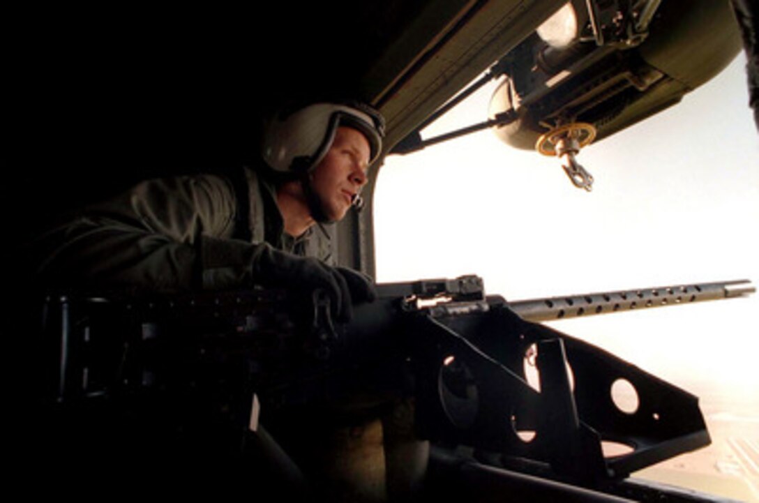 Marine Aircrewman Lance Cpl. J. R. Johnston watches out the door as his CH-53 Sea Stallion helicopter heads toward the landing zone near Yuma, Ariz., on April 17, 1997, during Exercise Desert Punch. Desert Punch is a simulated helicopter assault mission involving over 60 helicopters from nine squadrons of Marine Aircraft Group 16. The helicopters launched from Marine Corps Air Stations El Toro and Tustin, Calif., and rendezvoused at the designated landing zone outside Yuma. 