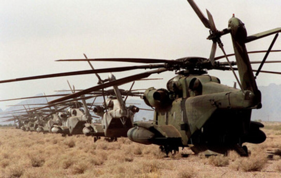 U.S. Marine Corps CH-53 Sea Stallion helicopters are parked in a line at the landing zone near Yuma, Ariz., on April 17, 1997, during Exercise Desert Punch. Desert Punch is a simulated helicopter assault mission involving over 60 helicopters from nine squadrons of Marine Aircraft Group 16. The helicopters launched from Marine Corps Air Stations El Toro and Tustin, Calif., and rendezvoused at the designated landing zone outside Yuma. 