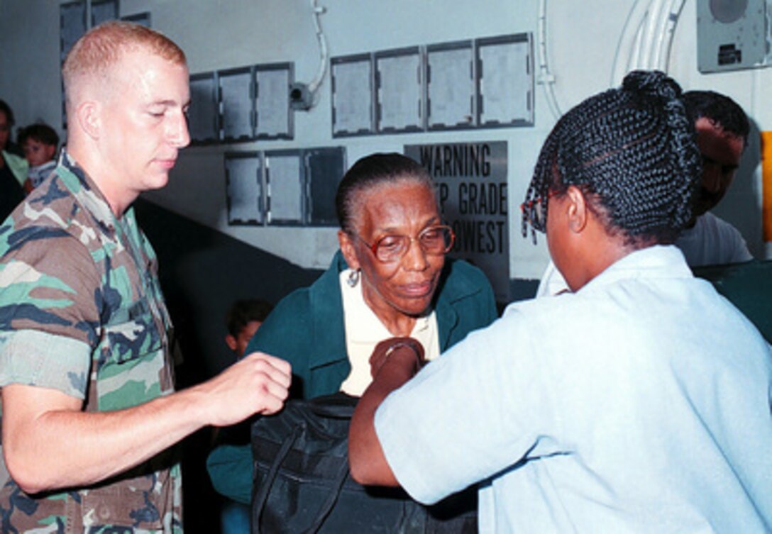 An evacuee from Freetown, Sierra Leone, is processed after arriving onboard the USS Kearsarge (LHD 3), on May 30, 1997, during Operation Noble Obelisk. Over 900 people from 40 different countries have been evacuated. 