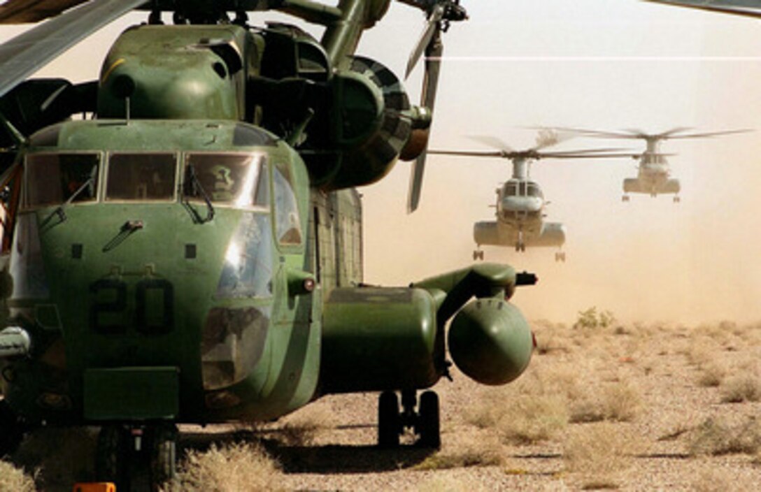 CH-46 Sea Knight helicopters stir up a cloud of dust as they launch behind a CH-53 Sea Stallion on the desert floor near Yuma, Ariz., on April 17, 1997, during Exercise Desert Punch. Desert Punch is a simulated helicopter assault mission involving over 60 helicopters from nine squadrons of Marine Aircraft Group 16. The helicopters launched from Marine Corps Air Stations El Toro and Tustin, Calif., and rendezvoused at the designated landing zone outside Yuma. 