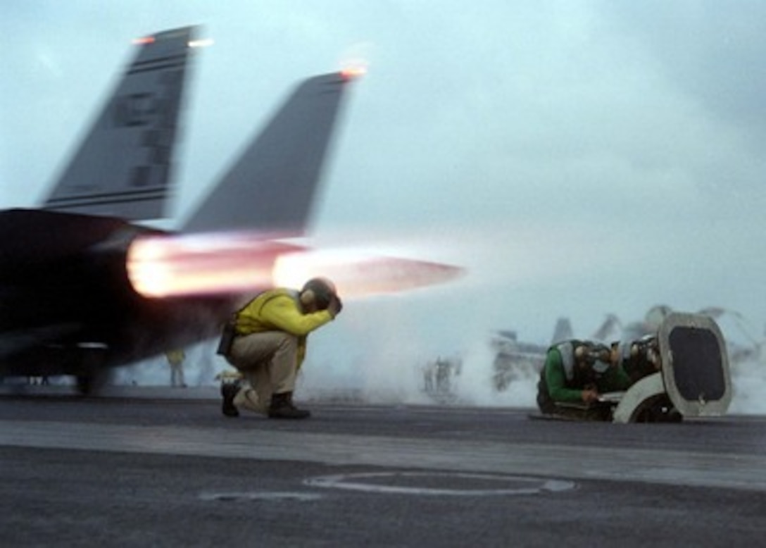 Navy Lt. Michael Stone from Valley Center, Calif., completes signal instructions to launch a F-14 Tomcat fighter from one of the four powerful steam driven catapult systems onboard the USS Nimitz (CVN 68) on Nov. 4, 1997. The Nimitz and Carrier Air Wing 9 are currently operating in the Persian Gulf in support of Operation Southern Watch, enforcing the UN No-Fly Zone over Southern Iraq. 