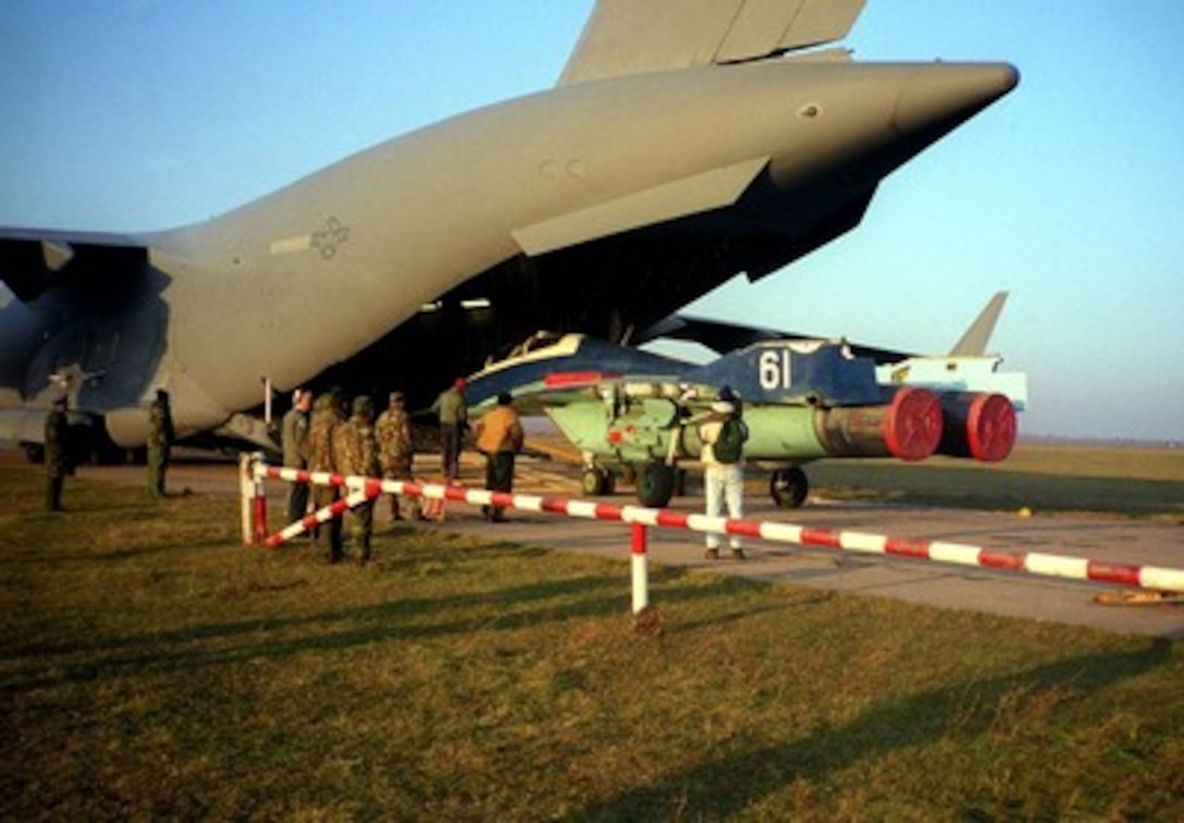 A MiG-29B trainer is winched into a U.S. Air Force C-17 Globemaster III for air shipment from Moldova to the United States on Oct. 28, 1997. The Department of Defense of the United States of America and the Ministry of Defense of the Republic of Moldova recently reached an agreement to implement the Cooperative Threat Reduction accord signed on June 23, 1997, in Moldova. This agreement authorized the United States Government to purchase nuclear-capable MiG-29 fighter planes from the Government of Moldova. This is a joint effort by both governments to ensure that these dual-use military weapons do not fall in to the hands of rogue states. The Globemaster is deployed from Charleston Air Force Base, S.C. 