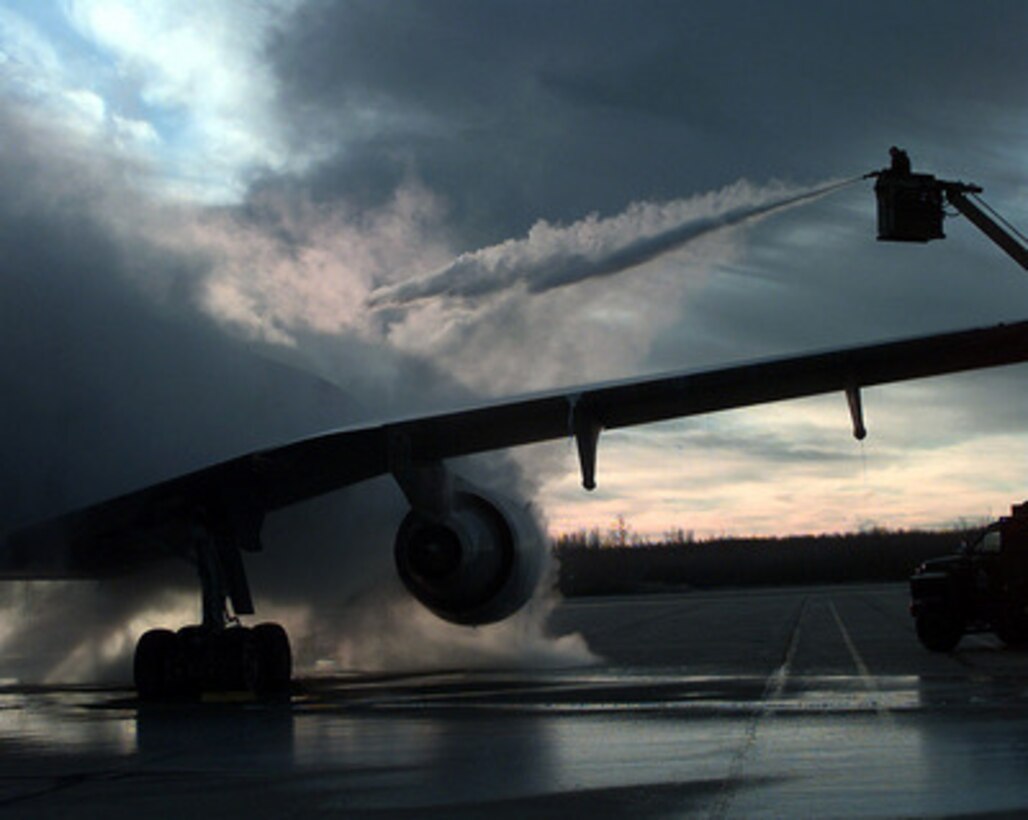 Senior Airman Dan Reedy sprays a steaming mist of de-icing solution that engulfs the fuselage of a KC-10A Extender as it prepares for an Exercise Amalgam Warrior mission from 4 Wing Cold Lake, Canada, on Nov. 4, 1997. Amalgam Warrior is a North American Aerospace Defense Command (NORAD) air intercept and air defense exercise for U.S. and Canadian forces. The KC-10A Extender is an aerial refueling tanker and transport aircraft deployed for the exercise from the 605th Aerial Refueling Squadron, McGuire Air Force Base, N.J. Reedy, from Baltimore, Md., is a crew chief from the 605th Aircraft Generation Squadron at McGuire. 