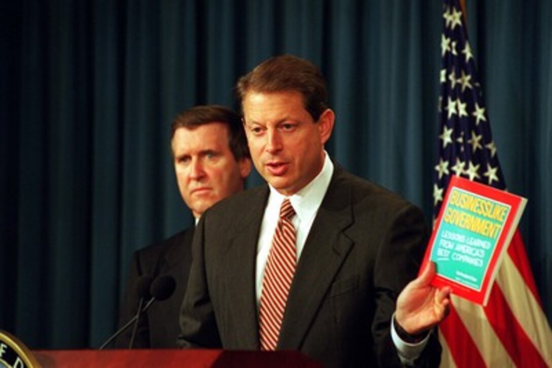 Vice President Al Gore holds up a copy of "Businesslike Government, Lessons learned from Americas Best Companies", to emphasis the intention of a sweeping program to reform the "business" of the Department of Defense announced at a Pentagon press briefing on Nov. 10, 1997. Gore joined Secretary of Defense William S. Cohen (left) in announcing the Defense Reform Initiative which will aggressively apply to the Department those business practices that American industry has successfully used to become leaner and more flexible in order to remain competitive. Gore endorsed the effort as exemplifying the objectives of the National Performance Review. 