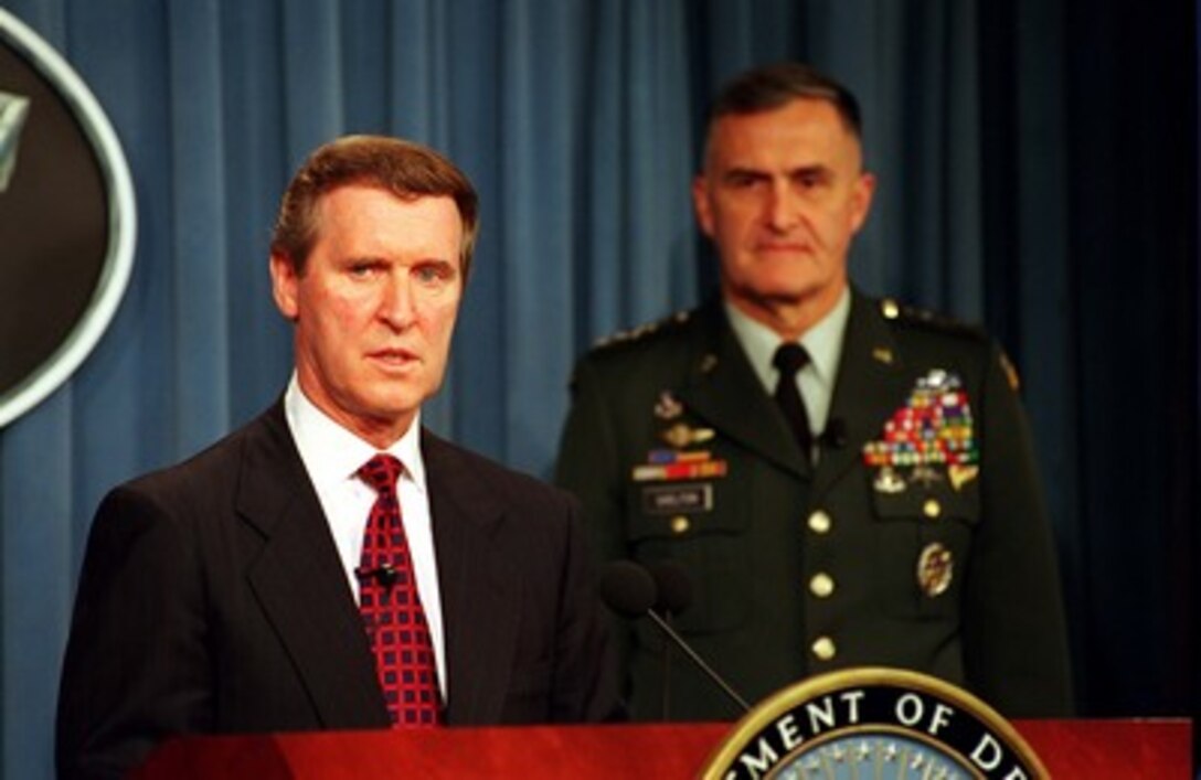 Secretary of Defense William S. Secretary (left) accompanied by Chairman, Joint Chiefs of Staff, Gen. Henry H. Shelton (right), U.S. Army, answers a question during the announcement of the Defense Reform Initiative at a Pentagon press briefing on Nov. 10, 1997. This Defense Reform Initiative will aggressively apply to the Department those business practices that American industry has successfully used to become leaner and more flexible in order to remain competitive. 