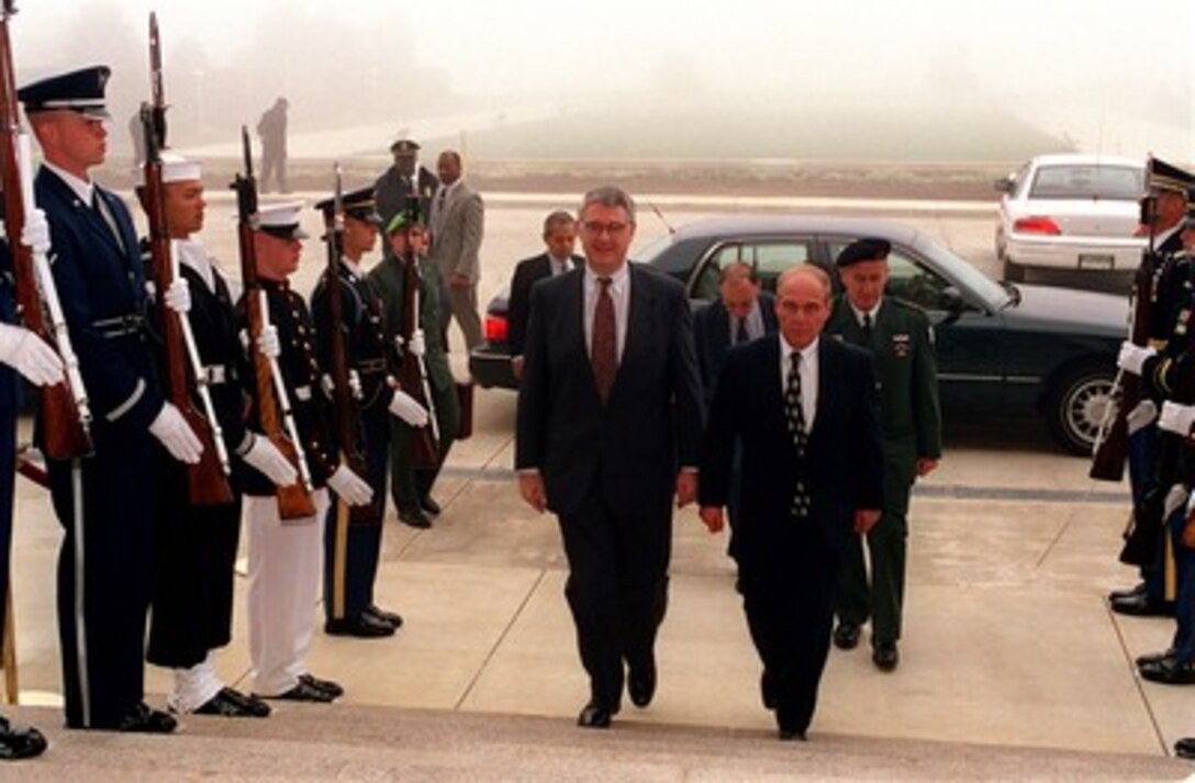 Deputy Secretary of Defense John J. Hamre (left) escorts Major Gen. Ilan Biran (right), director general, Ministry of Defense, State of Israel, through an armed forces honor cordon into the Pentagon on Oct. 31, 1997. 