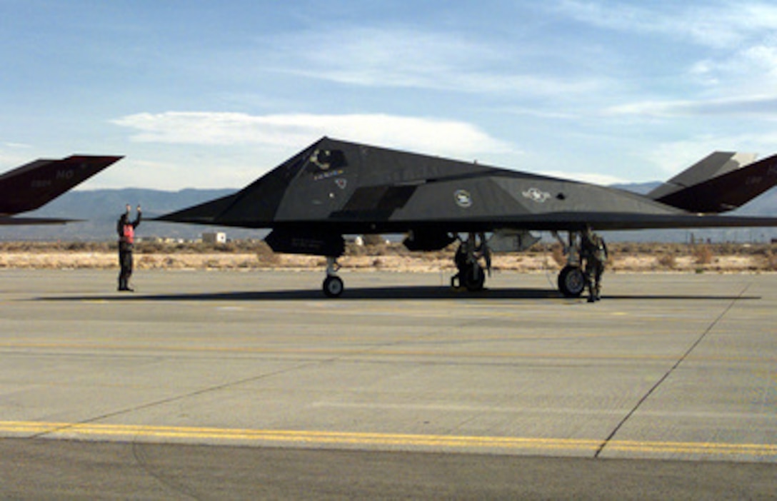 U.S. Air Force ground crew members do a final inspection of an F-117A Nighthawk aircraft before it departs for Kuwait from Holloman Air Force Base, N.M., on Nov. 19, 1997. Six of the stealth fighters will join a large force of approximately 120 U.S. Air Force aircraft in the region proving support to Operation Southern Watch which is the U.S. and coalition enforcement of the no-fly-zone over Southern Iraq. The aircraft are deploying to the Persian Gulf from the 8th Fighter Squadron at Holloman. 